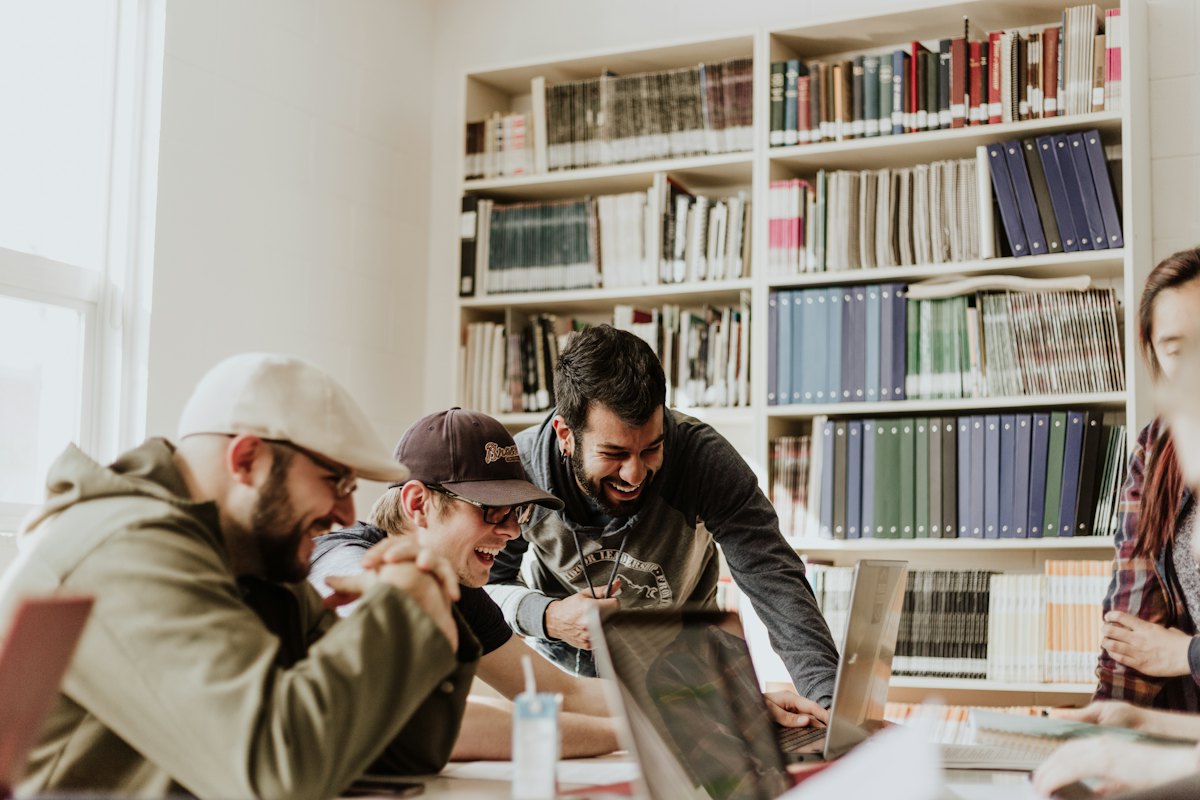 A group of people learning together around a laptop